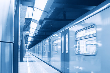 Moving train in subway station