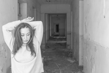 Asian beautiful girl is in a old building with a lot of snow on a background from Siberia.