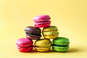 Pyramid of colorful, bright, traditional French Sweet macaroons on retro-vintage background