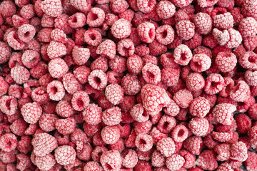 Ripe frozen raspberries top view.
