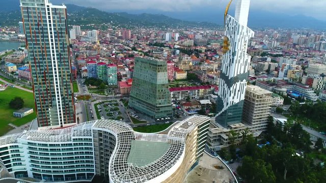 Panoramic aerial drone view of modern buildings of downtown of Batumi. Batumi technical university tower, Radisson Blu Hotel and Palm apartments from above