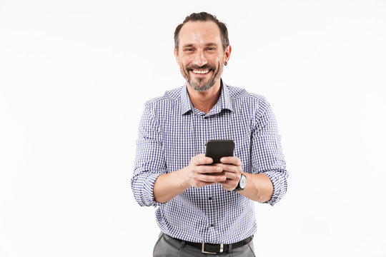 Cheerful adult man using mobile phone.