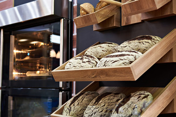 Fototapeta na wymiar Loaves of rye bread on shelf in bakery