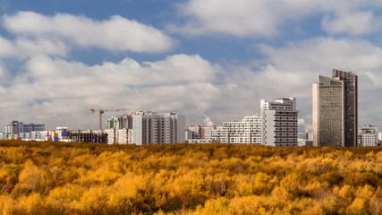 Fototapeta na wymiar October 2017, Moscow, Russia - aerial view of modern high rise residential buildings surrounded by autumn pak