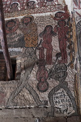 TIGRAY REGION, ETHIOPIA - February 06, 2018: wall murals of saints and iconographic scenes, painted in naive african christian style, on wall of Yohannes Meaquddi church