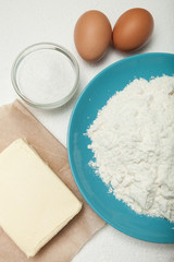 Prepared baking ingredients on white background.