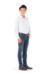 Portrait of confident Asian man wearing shirt and jeans posing on white background