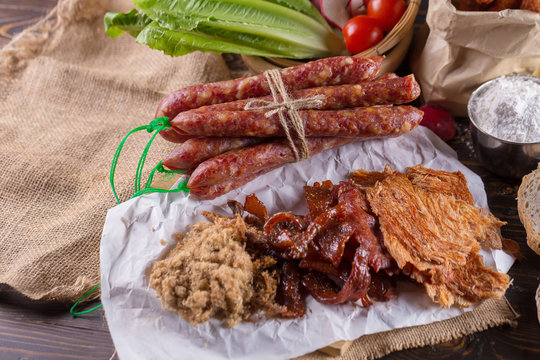 Chinese sausage and Pounded pork jerky for cook on a wooden background