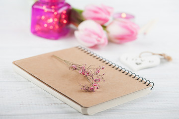 Notebook, flowers and pink lights
