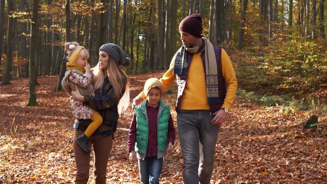 Cheerful family walking in the autumn 