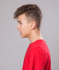 Close up profile emotional portrait of caucasian teen boy. Handsome sad guy. Funny cut teenager on...