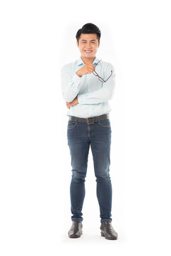 Portrait of young Asian man holding eyeglasses isolated on white