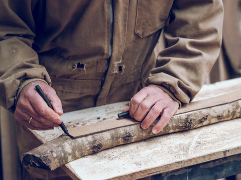 Carpenter working with branch