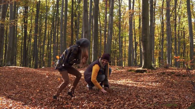 Couple having a fun with leaves 