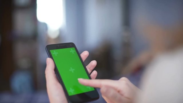 woman using a Smartphone with green screen