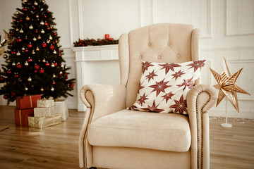 Christmas Tree and Christmas gift boxes in the interior with a fireplace.
