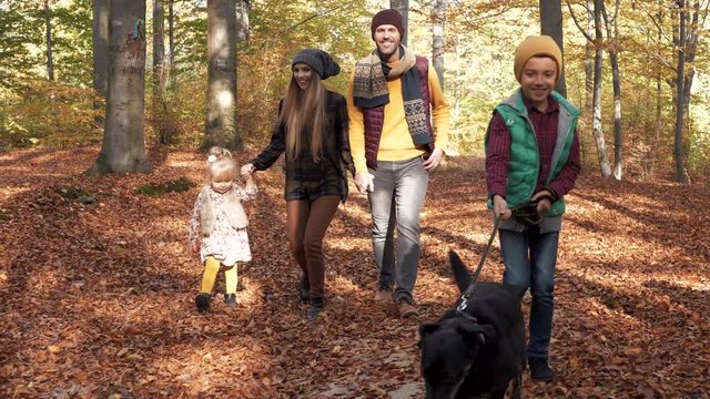 Family with dog walking in the autumn  