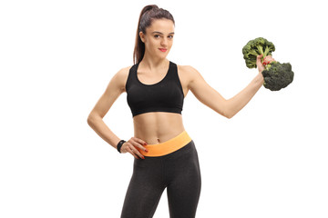 Fitness woman holding a broccoli dumbbell