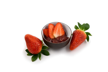 Strawberry jam stock images. Strawberry with jam on a white background. Marmalade in a bowl. Breakfast still life
