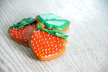 Two gingerbreads in the form of red strawberries. Close-up