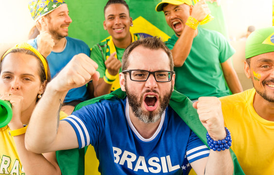 Brazilian fans at stadium. Cheering.