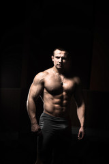 Obraz na płótnie Canvas Portrait of a bodybuilder on a black background