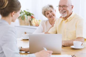 Happy seniors with insurance agent