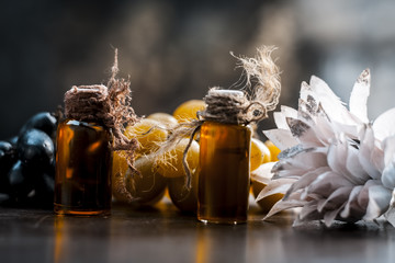 Close up of grapes oil on a wooden surface in dark  Gothic colors  to improve overall hair growth.It is rich in source of vitamin A,K and C along with flavonoids and minerals.