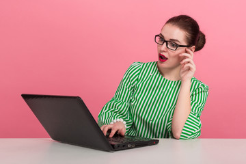 Businesswoman with hair bun and laptop