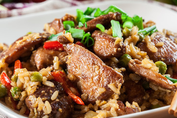 Fried rice with chicken and vegetables served on a plate