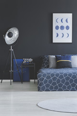 Dark bedroom interior with poster