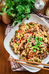Fried rice with chicken and vegetables served on a plate