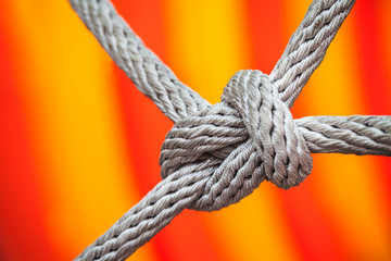 Close-up of rope knot line tied together with playground background.selective focus.