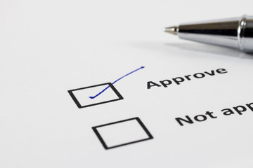 Close up check box approve or not approve for hand signed and blur pencil on white paper