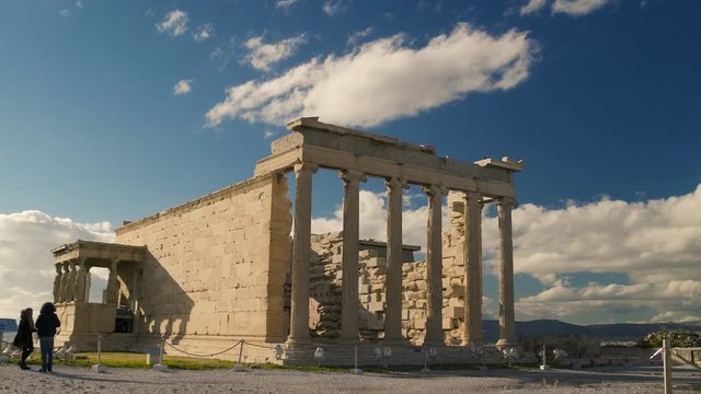 Towering Greek Ruins. The Acropolis is one of the most important ancient monuments in the world with archaeological structures including: The Acropolis, Erechtheion, Parthenon, Propylaea, and more. 
