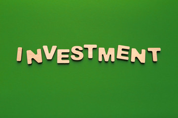 Word Investment spelled with wooden letters