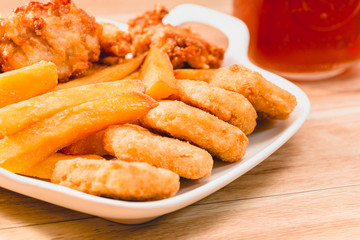 Chicken nuggets and ice tea on Wooden Placemat