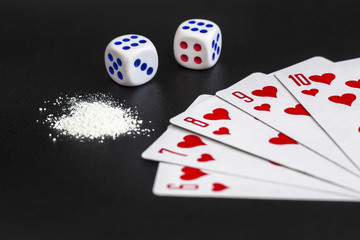 Concept of gambling addiction. Gambling table with playing poker cards, dices and drug