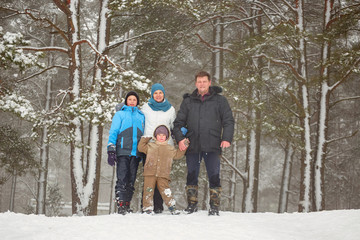 Fototapeta na wymiar portrait of a happy family on a winter forest background.