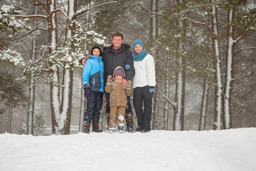 portrait of a happy family on a winter forest background.