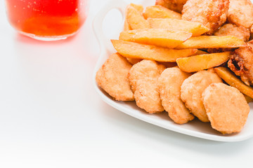 Chicken nuggets and ice tea on white background