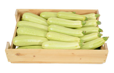 Zucchini in wooden box on white background