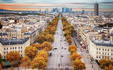 La Defense Financial District Paris France at sunset in autumn. Traffic on Champs-Elysees with...