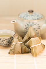 Zongzi or Traditional Chinese Sticky Rice Dumplings on Wooden Placemat