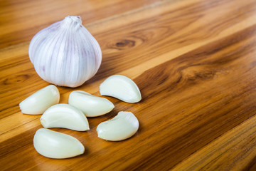 Fresh garlic on a wooden background.