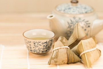 Zongzi or Traditional Chinese Sticky Rice Dumplings on Wooden Placemat