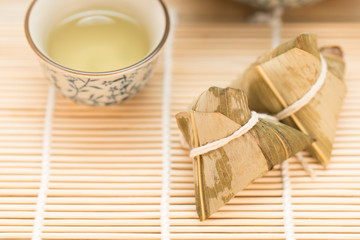 Zongzi or Traditional Chinese Sticky Rice Dumplings on Wooden Placemat