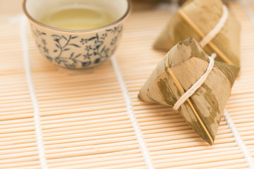 Zongzi or Traditional Chinese Sticky Rice Dumplings on Wooden Placemat