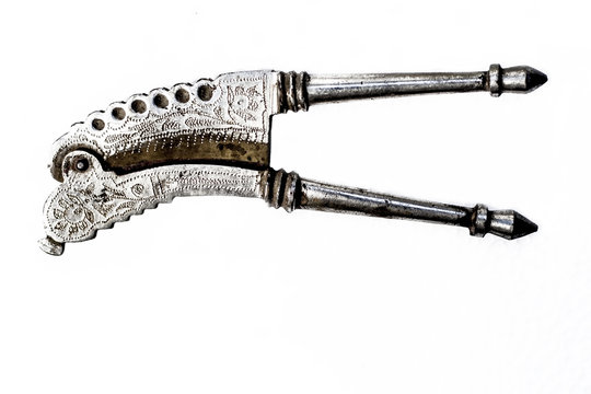 Close up of Old vintage supari cutter or betel nut cutter isolated on a white surface.