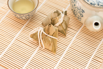 Zongzi or Traditional Chinese Sticky Rice Dumplings on Wooden Placemat